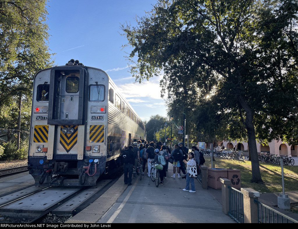 Several people board Amtrak Train # 547 at Davis, many of which are college students who attend UC Davis.